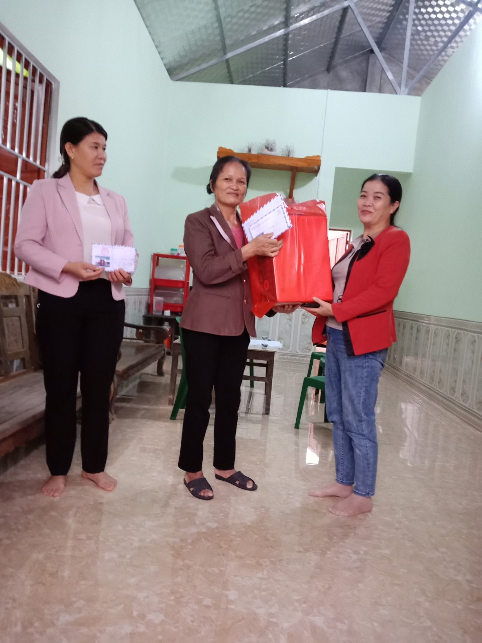 Chủ tịch Hội Nông dân thị trấn Nước Hai tặng quà cho gia đình hội viên nông dân Phương Thị Hương xóm Thái Cường
